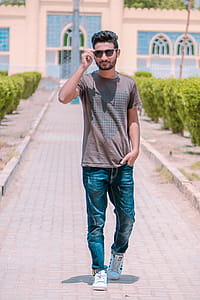 Man in Brown Shirt Holding His Sunglasses thumbnail