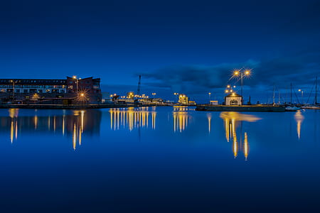 photo of ships on calm body of water during nighttime thumbnail