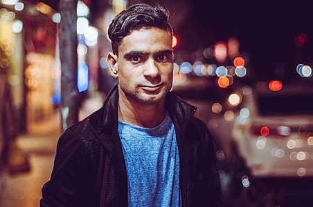 Man Wearing Black Zip-up Jacket And Blue Top thumbnail