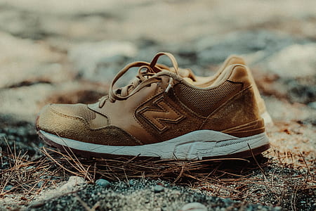 closeup photo of pair of beige New Balance low-top sneakers thumbnail
