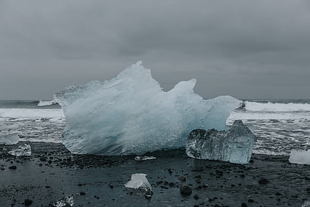 large ice on seashore under gray sky thumbnail