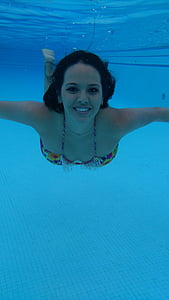 woman wearing purple and yellow bra while swimming thumbnail