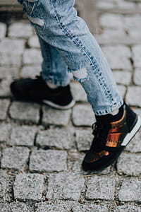 Woman in black sneakers and blue jeans thumbnail