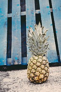 pineapple near blue wooden fence thumbnail