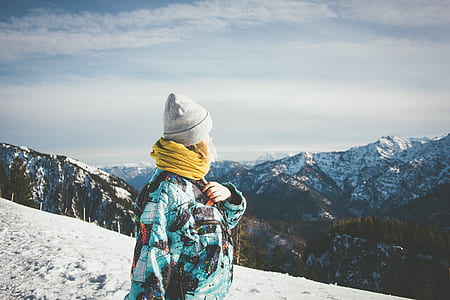 woman standing on snow covered cliff thumbnail