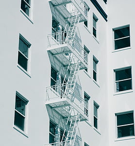 view of emergency exit besides concrete building thumbnail