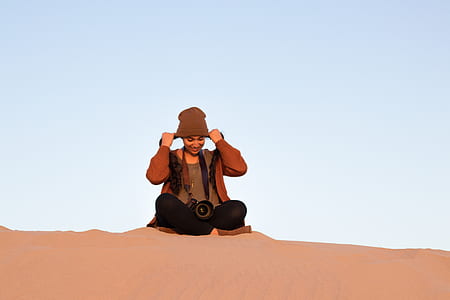 woman sitting on desert thumbnail