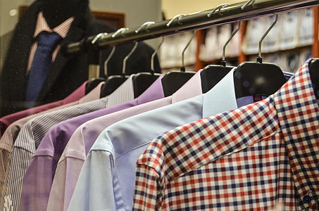 assorted-color dress shirts hanging on clothes rack thumbnail