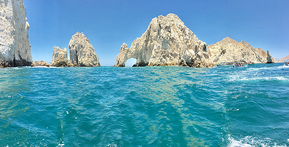 grey mountain formation on the sea under the blue sky thumbnail