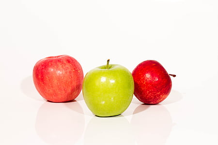 two red and one green apples on white surface thumbnail