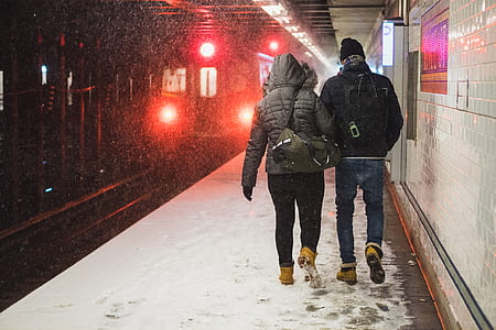 man and woman standing near train thumbnail