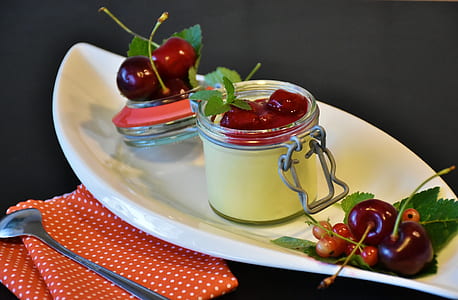 photo of air-tight jar filled with red cherry in white boat bowl thumbnail