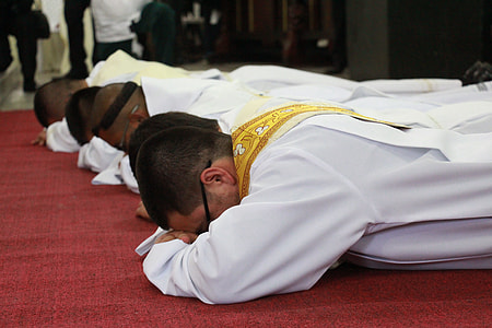 four priests bowing on floor thumbnail