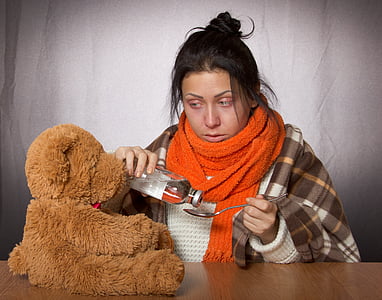 woman holding silver spoon and glass bottle thumbnail