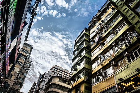low-angle photo of buildings under blue sky during daytime thumbnail