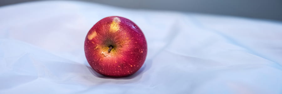 Red Apple Fruit on White Textile thumbnail