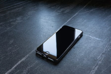turned off black iPhone 7 on wooden surface thumbnail