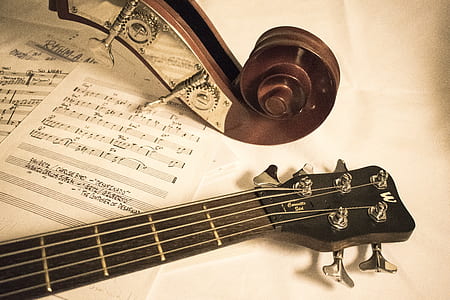 brown acoustic guitar beside music note paper thumbnail