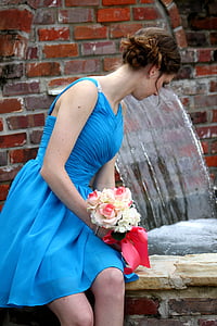 woman in blue spaghetti strap dress holding bouquet of flowers thumbnail