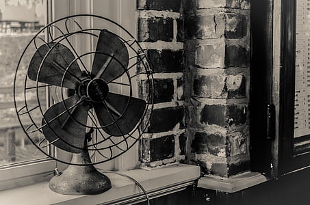 grayscale photography of desk fan near window thumbnail