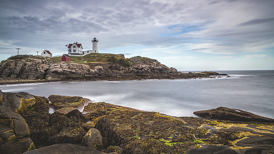 long exposure brown stones with lighthouse and building thumbnail