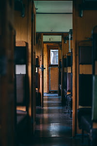 pathway in the middle of brown and purple wooden chairs thumbnail