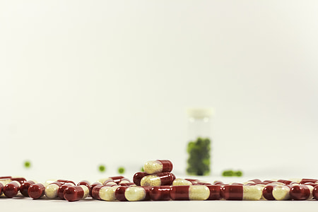 close up photography of white and red capsules thumbnail