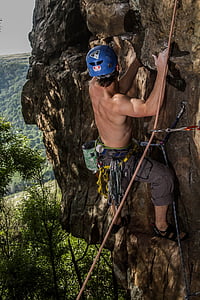 man climbs mountain during daytime thumbnail