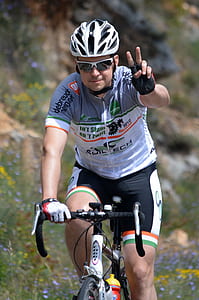 man riding road bike while doing peace hand sign thumbnail