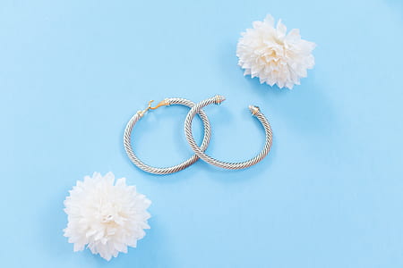 silver-colored hoop earrings with white clustered petaled flower thumbnail