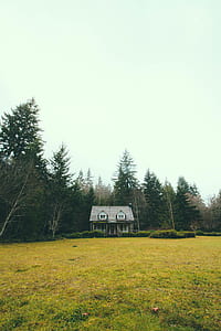 front view of brown 2-storey house in front of grass fields thumbnail