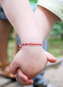 two toddlers holding hands thumbnail
