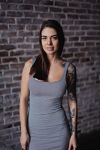 tilt shift lens photography of woman with full sleeve tattoo thumbnail