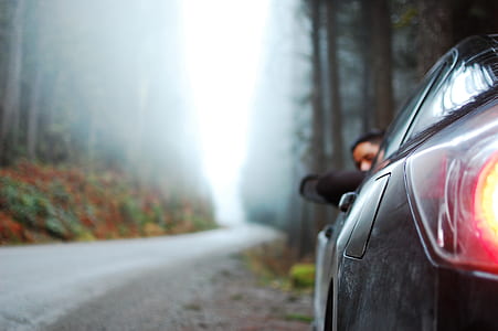 selective focus photography of black car parked in street thumbnail