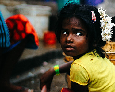 girl wearing yellow tee shirt with white flower headress thumbnail