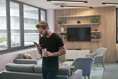 Man in Black Shirt Standing While Holding Drinking Glass thumbnail