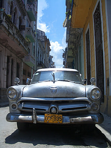 white vehicle between building at daytime thumbnail
