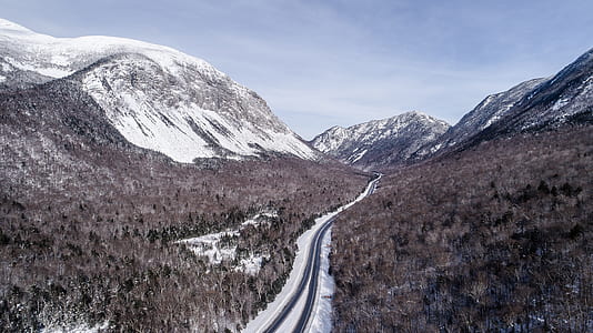 snow-covered mountain near concrete road thumbnail