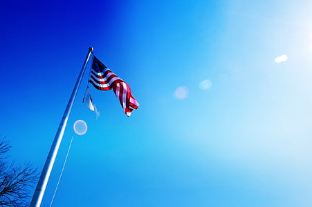 USA flag on pole under blue sky at daytime thumbnail