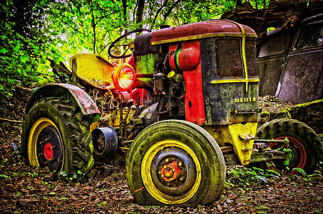 red tractor parked in the woods thumbnail