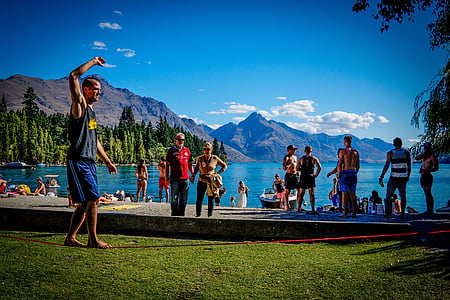 group people having picnic near lake thumbnail