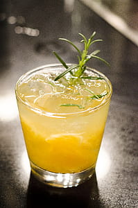 Clear Glass Cup With Yellow Liquid Inside thumbnail