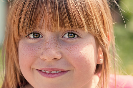 shallow focus photography of child's face thumbnail