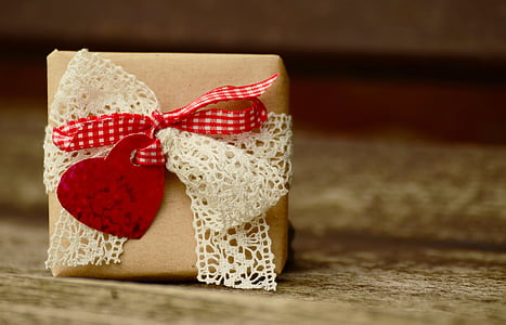 brown candle with white and red lace thumbnail