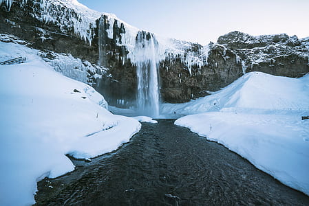 waterfalls on snow-covered cliff thumbnail