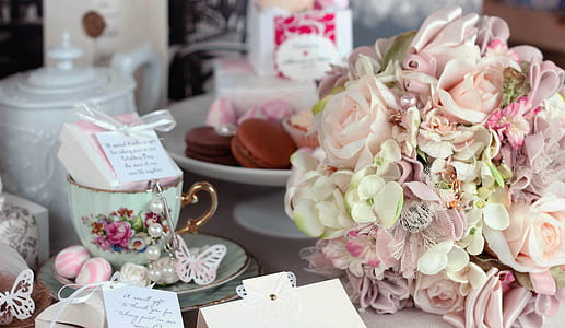 pink and beige rose bouquet placed near teacup thumbnail