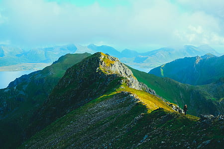 green mountain under white clouds at daytime thumbnail