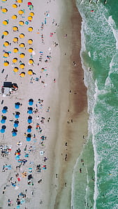 aerial photography of people on beach during daytime thumbnail