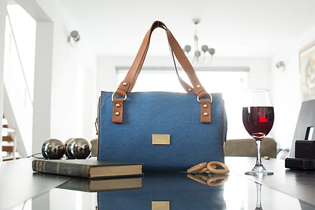 blue and brown tote bag beside wine glass thumbnail