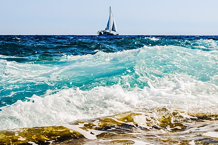 white and blue boat on body of water thumbnail